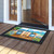 Beach Chairs Doormat with colorful beach scene and palm tree design on wooden porch floor.