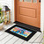 Black Flip Flop Haven Mini Mat with colorful flip flop design on a wooden porch floor.