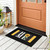 Black Sunflower Home Mini Mat with white and yellow design on wooden porch floor.
