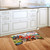 Farm Pups Doormat on wooden floor in front of white kitchen cabinets and sink area.