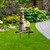Lighthouse At Sunset Metal Art, red and white striped lighthouse sculpture on grassy lawn outdoors.