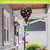 Rainbow Pawprints Welcome Hot Air Balloon Spinner with colorful pawprint design on a pole outdoors.