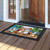 Summer Chipmunks doormat with colorful beach scene and black border on wooden porch floor.