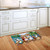 Summer Chipmunks doormat on wooden floor in front of kitchen sink with tropical design and seashells.
