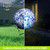 Blue Speckled Solar LED Glass Gazing Ball with stand, daytime and nighttime view, decorative outdoor lighting.