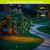 Green Leaves Solar LED Mosaic Gazing Ball by Briarwood Lane, illuminated on garden lawn stand.