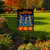 Skeleton Dance Party Garden Flag with dancing skeletons, pumpkins, and "Happy Halloween" text on display.