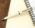 Sailor 1911 Standard Ballpoint - Ivory with Gold Trim - On Notebook