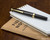 Pilot E95S Fountain Pen - Black - Closed on Notebook