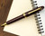 Sailor 1911 Large Ballpoint - Maroon with Gold Trim - Open on Notebook