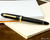 Sailor 1911 Large Fountain Pen - Black with Gold Trim - Closed onNotebook