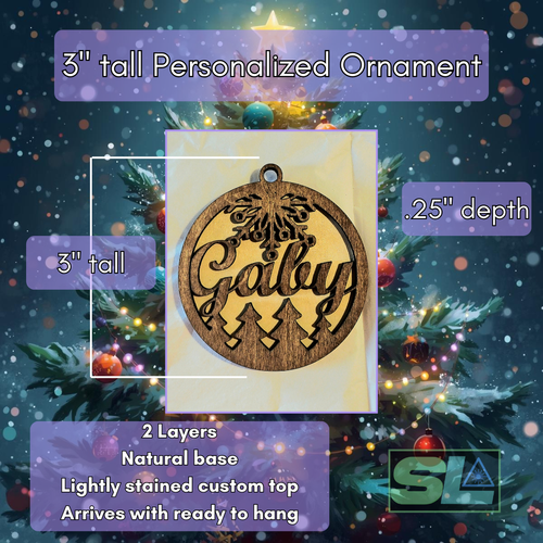 Personalized wooden Christmas ornament with laser-cut name, snowflake design, and pine trees