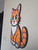 Handcrafted wooden cat wall sign hanging on brick wall, playful cat themed home décor