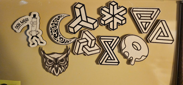 Custom wooden magnets with personalized designs, handmade and rustic, displayed on a fridge or magnetic surface.