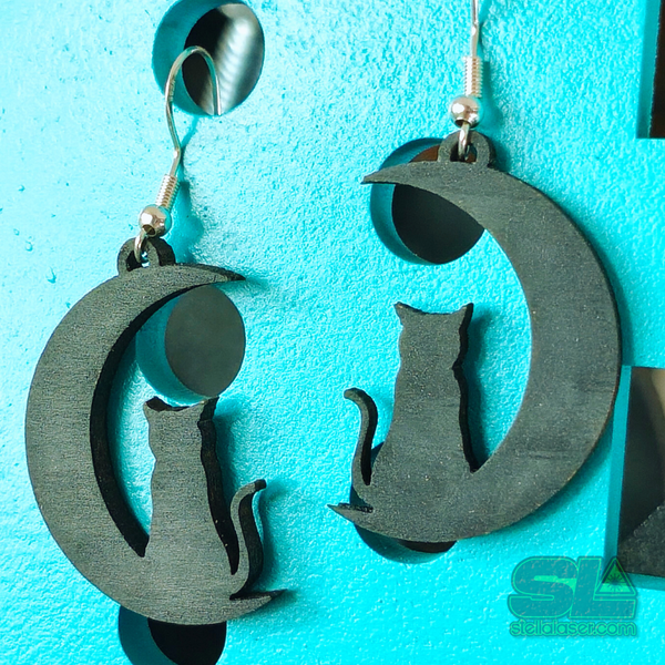 Close-up of wooden black cat moon earrings with detailed silhouette and smooth painted finish