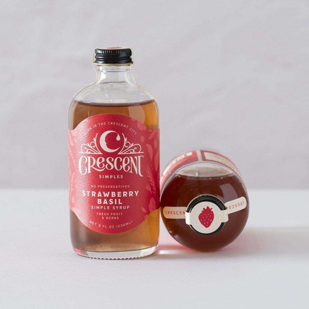 A bottle of Crescent Simples Strawberry Basil simple syrup.
