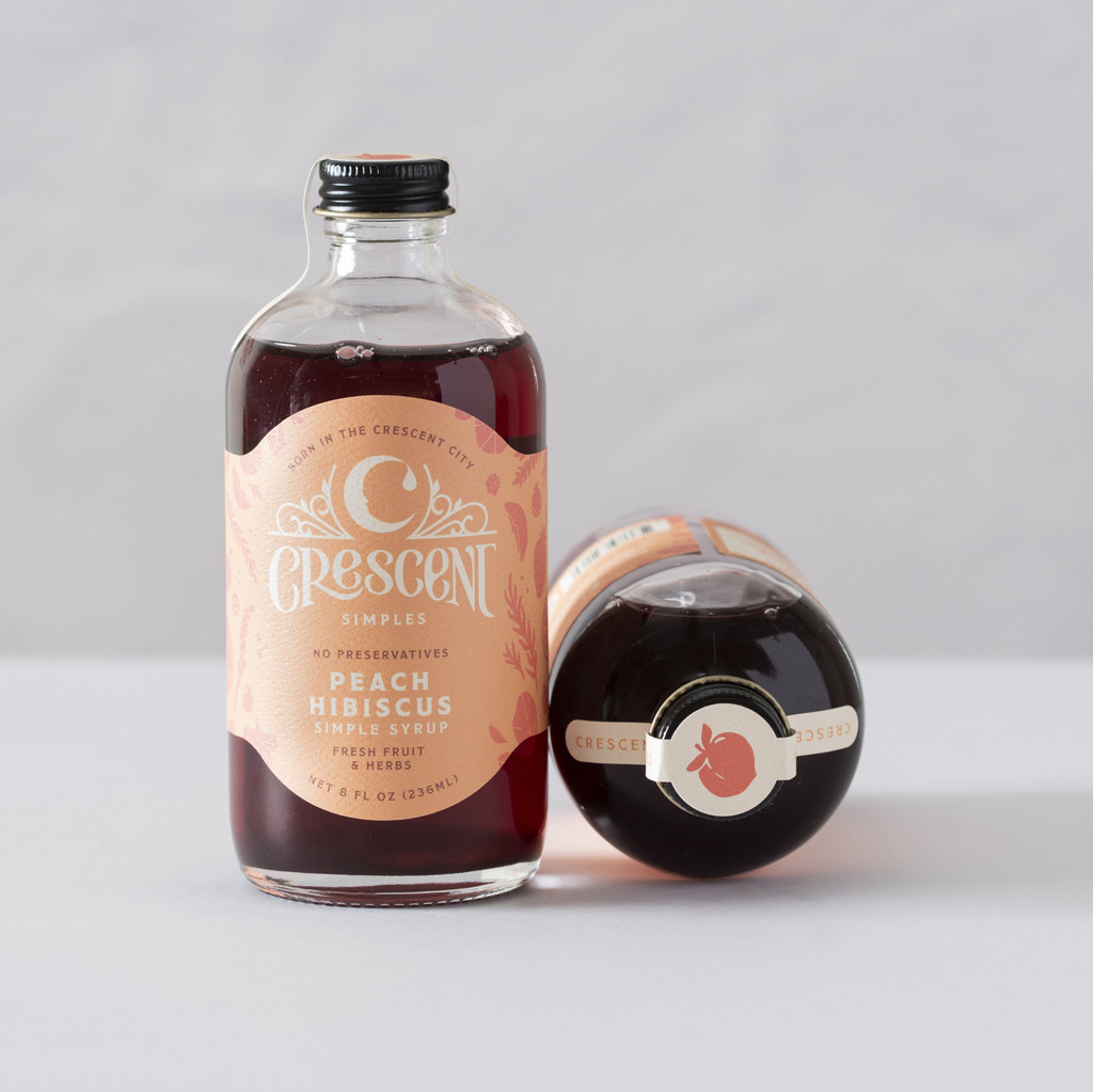 A bottle of Crescent Simples Peach Hibiscus simple syrup.