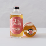 A bottle of Crescent Simples Grapefruit Rosemary simple syrup.