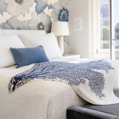 Fan Coral Knit Throw in Navy Blue  on bed