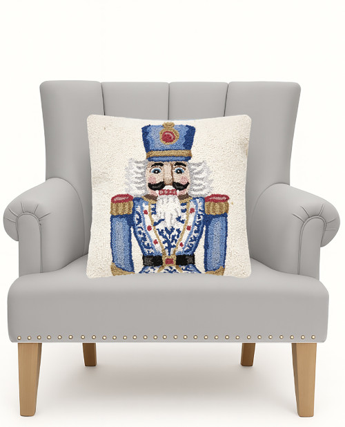 Holiday Chinoiseries Nutcracker Hooked Pillow on a chair