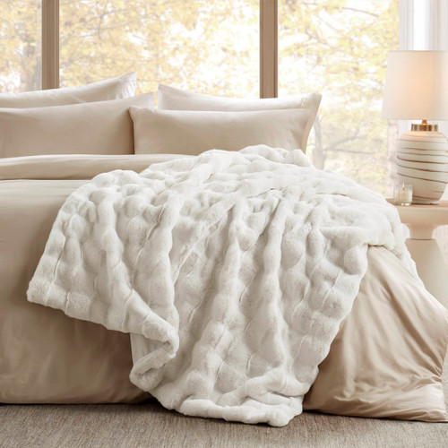 Villa Mar Ivory Faux Fur Throw on bed