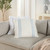 Seal Beach Blue Shore Linen Striped Throw Pillow on sofa