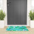 Blue-Green Palm Tree Coast Welcome Mat in front of door
