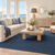 Midnight Blue Drift Modern Coastal Rug room example with kenzie lamp and rope mirror