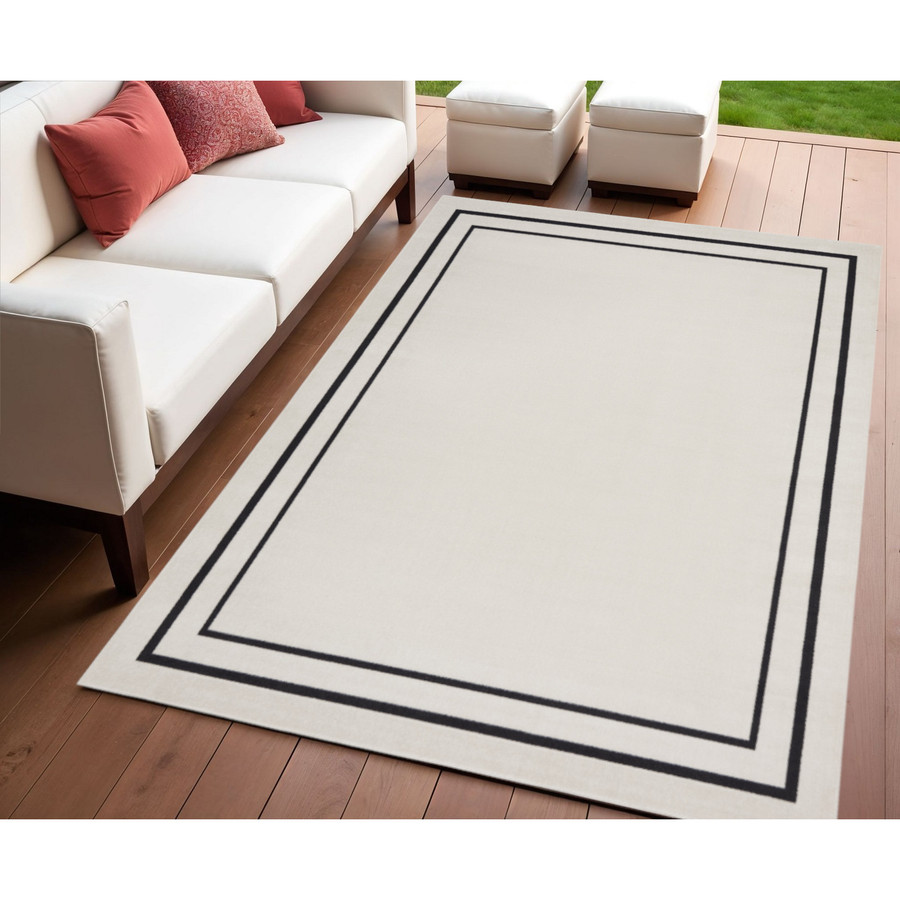 Ivory and Black 4' X 6' Indoor and Outdoor Area Rug
