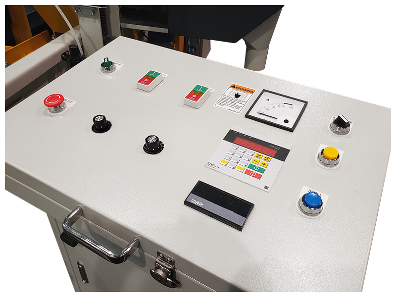 Mobile Control Panel 
The machine controls & electrical panel are mounted in a mobile pedestal which can be positioned to a convenient location by the operator. The control panel consists of a digital thickness controller to set the height of the sawblade. In addition there are individual controls for the variable feed speed of the sawblade and conveyor belt. The speed of the conveyor is shown on a digital display. An ammeter display shows the amp draw during cutting to allow the operator to adjust the feed or blade speed for optimum blade life
