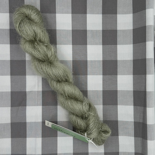 Image of hank of Monsoon G50 (a soft wispy sage green) Bonmoher super kid mohair and silk yarn from Urth Yarns