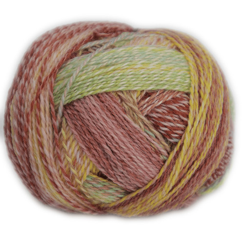 A ball of Schoppel Yarn, Zauberball Crazy #2545 in spring flower shades of soft coral, pink, green and yellow.