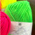 closeup of Cascade Yarns - Pacific Bulky - Neon Green 199 with Neon Yellow 198 and Neon Raspberry 196 on the sides