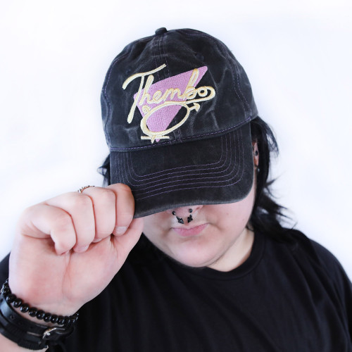 Thembo Throwback Cap by Crushworthy - Fun retro embroidery that says "Thembo" with a trans symbol below it, embroidered directly onto an acid wash black baseball cap.