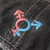 Trans Throwback Cap by Crushworthy - A fun retro embroidered design that says "Trans" with the trans symbol below it on an acid wash black baseball hat.