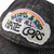 Bottoms & Tops We All Hate Cops Cap by Crushworthy - Pastel embroidery that says "Bottoms & Tops We All Hate Cops" on top of a rainbow with clouds below it, embroidered directly onto an acid wash black baseball cap.