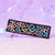 Transpeople Are Not The Enemy keychain by Crushworthy - Trans pride colored symbols on one side, and text reading "transpeople are not the enemy" on the other of a durable embroidered keychain