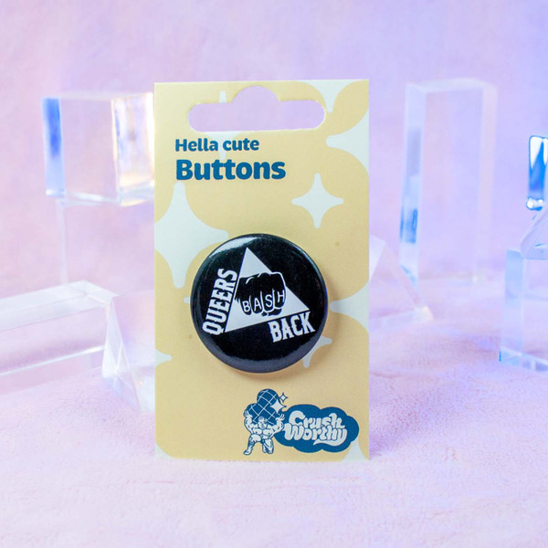 Queers Bash Back button by Crushworthy - "Queers Bash Back" text with a fist and a triangle on a stark black button for maximum visibility!