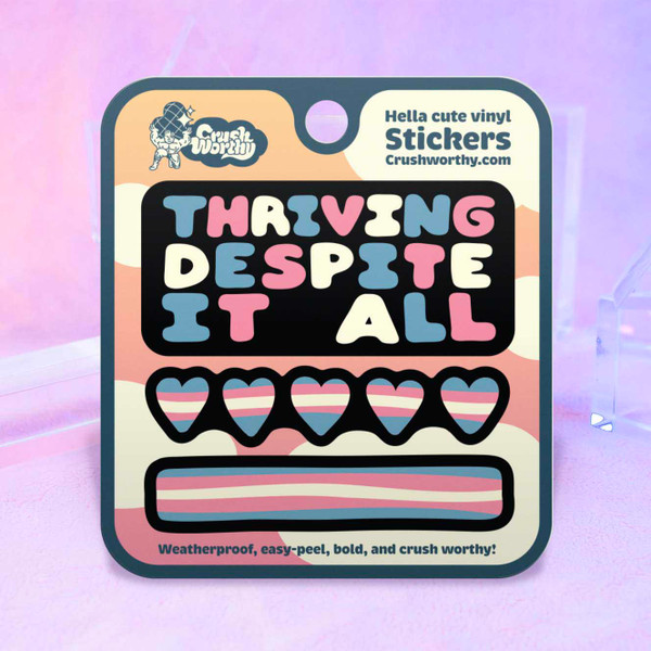 Thriving Despite It All sticker sheet by Crushworthy - Trans pride colors on sticker with a message that speaks to your resilience! Comes with a trans pride heart strip sticker, and a trans pride flag strip sticker.