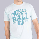 Close up front view of Pickleball Central's Heritage Pickle-ball Groovy Front Logo Unisex T-Shirt on a male model in the color Ice-Blue.