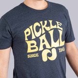 Close up front view of Pickleball Central's Heritage Pickle-ball Groovy Front Logo Unisex T-Shirt on a male model in the color Midnight Blue.