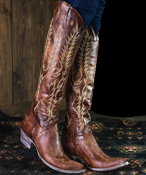 The Old Gringo Mayra Brass Boots are just another example of a masterpiece from the Old Gringo Boot Company. The Mayra Boots have been handcrafted from the softest, most beautiful brass brown leather you've ever seen or felt. The 18-inch boot shaft has been decorated with beautiful whimsical embroidery etched in shiny, golden-brown thread. 