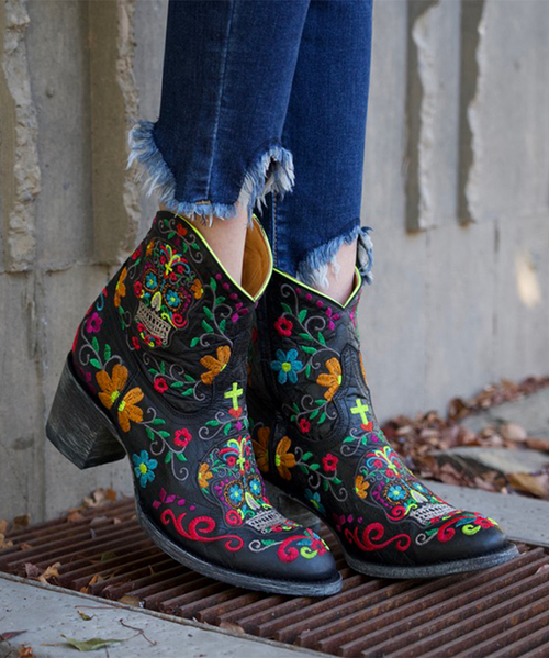 Liven up your wardrobe with this fantastic boot from Old Gringo! Handmade in Mexico and constructed of the finest black leather, it features gorgeous neon floral and sugar skull embroidery. Versatile and funky, this boot looks great with everything from jeans to dresses! 
