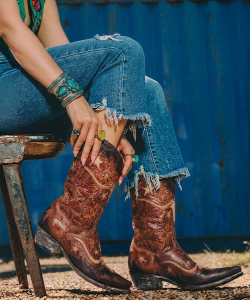 Meet Bodacious 10" by Old Gringo—a bold, attitude-packed boot that doesn’t just walk into a room, it owns it ?✨

Crafted in a rich blend of brass, bone, and chocolate brown, this standout style delivers that perfectly broken-in, vintage feel with a modern edge. The layered tones create depth and character, making each pair feel one-of-a-kind—just like the woman wearing them.

The 10-inch shaft hits at that sweet spot for versatile styling—easy to pair with dresses, denim, or cutoffs—while the sleek 4Long snip toe adds a touch of feminine sharpness and unmistakable Western flair.

Whether you're dressing up your everyday look or making a statement after dark, Bodacious brings confidence, character, and just the right amount of sass to your collection ?

Details:

Shaft Height: 10"
Color: Brass / Bone / Chocolate Brown
Toe Shape: 4Long Snip Toe
A little vintage, a little rebellious—and completely unforgettable.