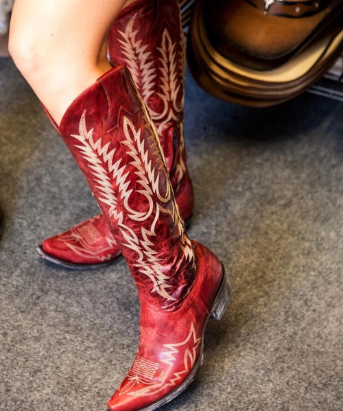 Boots are made for walking AND looking amazing, and the Old Gringo Mayra Boots are SO on trend. These aren't just cowgirl boots; these are fabulous fashion boots. Handcrafted in Leon, Mexico with gorgeous distressed red leather and accented with white embroidery.