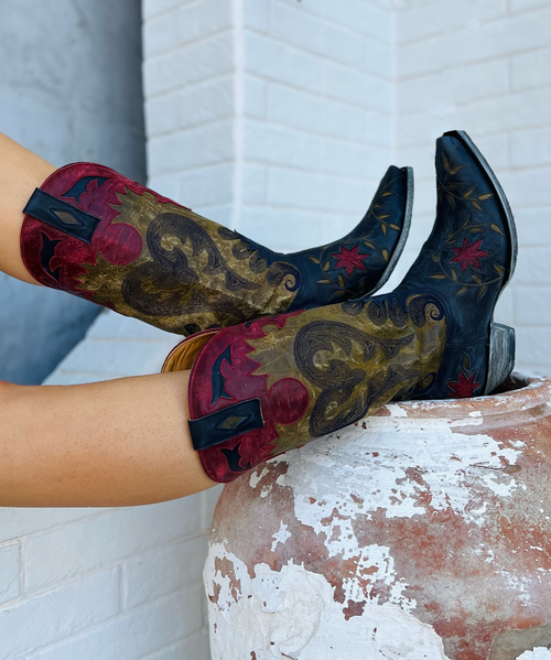 Gotta love the colors on the Old Gringo Letty Boots L1115-8. The marine blue and military green boot shaft mixes beautifully with the vesuvio red leather accents. The Letty boot was made for ladies looking to make a bold fashion forward statement. The floral designs on the toe are beautiful and the heart shaped embroidery on either side of the boot shaft gives it a sassy finish.
