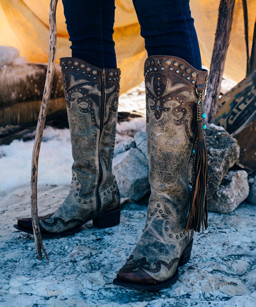 We just can't get enough of the Old Gringo Letty. The midnight black and buttercup gold boot shaft mixes beautifully with the vesuvio pink leather accents. The Letty boot was made for ladies looking to make a bold fashion forward statement. The floral designs on the toe are beautiful and the heart shaped embroidery on either side of the boot shaft gives it a sassy finish. Add the Old Gringo Letty boot to your collection...I can promise you won't be sorry!

Toe - Snip

Heel - 9964 Walking Heel

Vesuvio Black leather foot 

Buttercup leather shaft

red floral inlay on foot

pink leather collar

Leather upper, lining, insole, and outsole

stacked leather western heel

single stitch welt

13 in shaft height