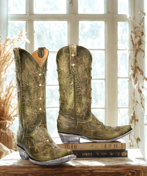 Women's Military Green Polo stud boot, antique brass studs are placed strategically on boot, connected by a 3 line stitch pattern, worn finish on heel & leather outsole.

Old Gringo boots go through a 130 step handmade production process.

Old Gringo also develops and tans its own leathers and textures to make sure the end result is a superior quality product.


Leather: Military Green Cowhide


Toe: Snip


Heel: 9964 - 1 1/2" High


Shaft: 13"