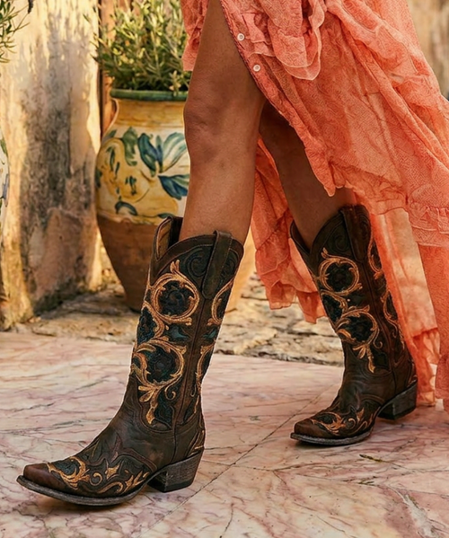 The Old Gringo Abelina features a beautiful hand tooled floral pattern creating a vintage romance feel.  No matter the occasion, the Abelina will fit in, casual or dressed to the nine's this is the cowgirl boot for you.  

* Style number: L2408-3

* Premium Goat Leather.

* 13 inch Chocolate foot and shaft.

* Brown/floral hand-tooled overlay detail.

* Snip toe.

* Single stitch welt.

* Leather lining.

* Leather/cushioned insole.

* Leather outsole.