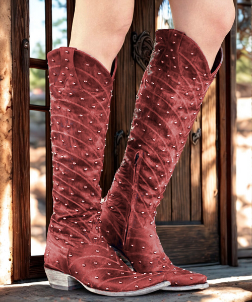 Silver studs and metallic stitching glam up this handcrafted Western boot by Old Gringo. 
Leather upper covered in silver studs.
Traditional 0 pointed toe.
Decorative metallic stitching.
Western-style layered vamp.
18" split-front shaft height
13" calf circumference.
Leather lining and distressed sole.
9964 Walking 1 1/2" stacked leather heel.
"Hosifookami" is handmade in Mexico.